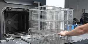 Pushing baskets in parts washer