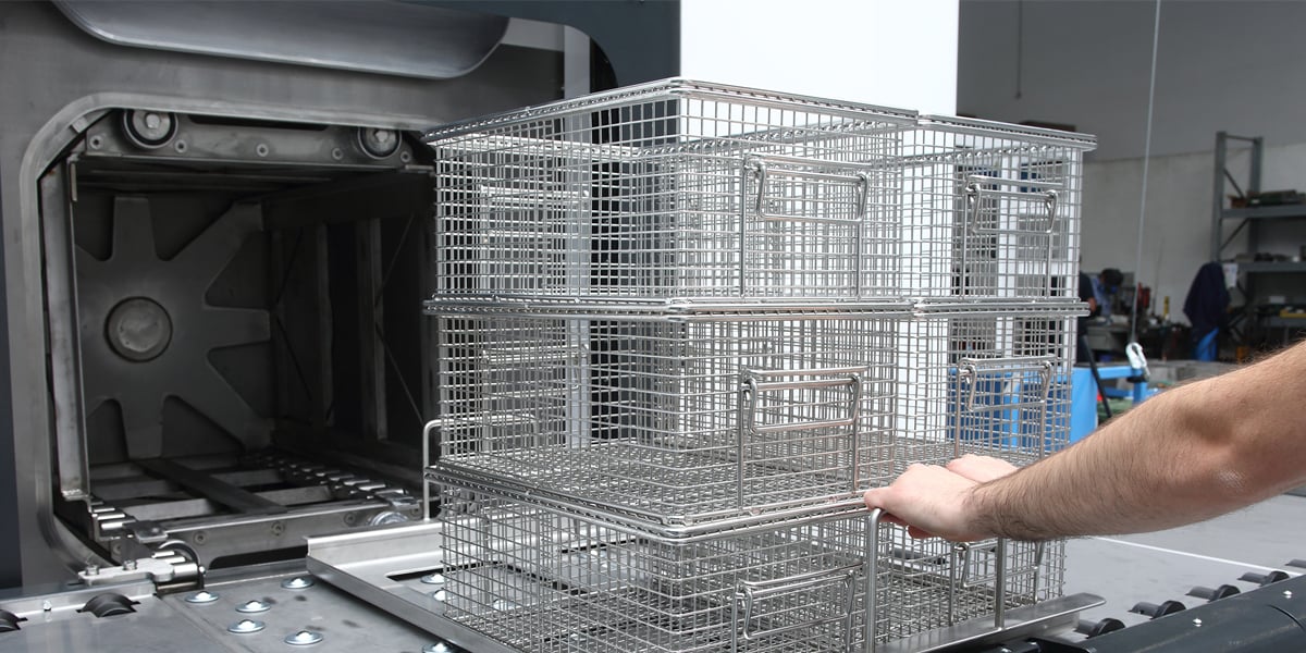 Pushing baskets in parts washer